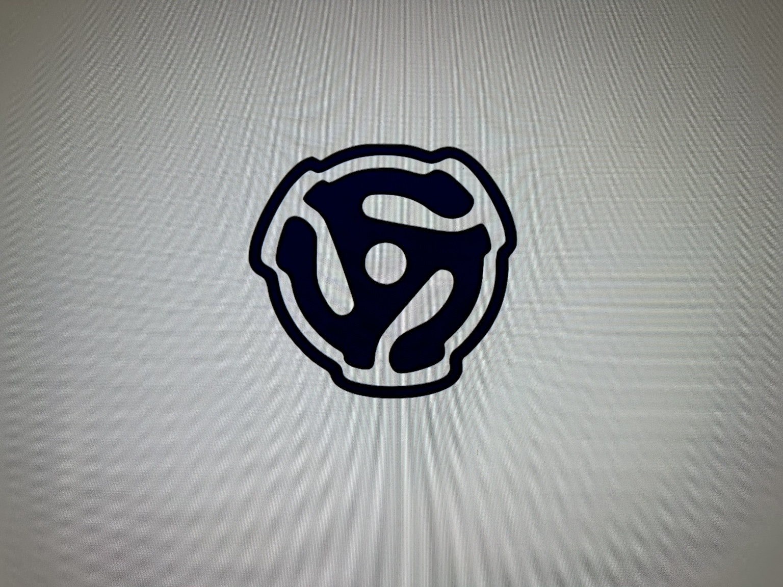 A classic 45 RPM record adapter symbol