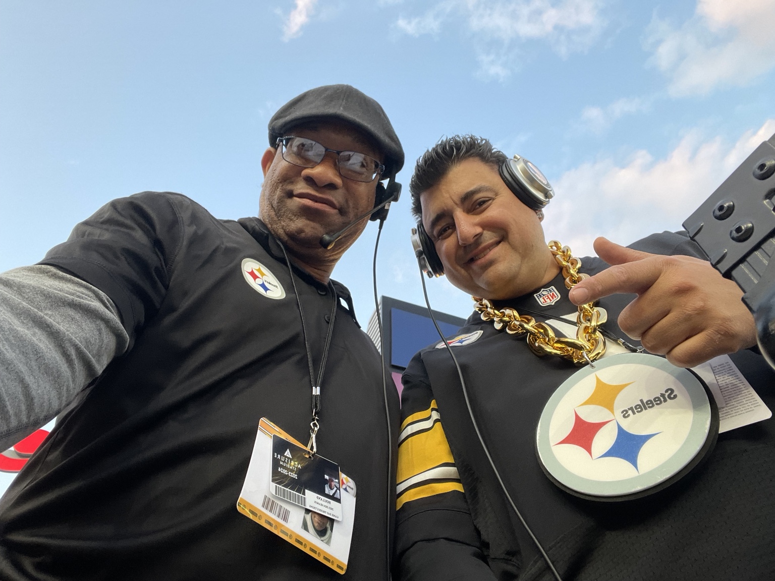DJ Holland and a fellow Steelers DJ wearing headsets at Acrisure Stadium