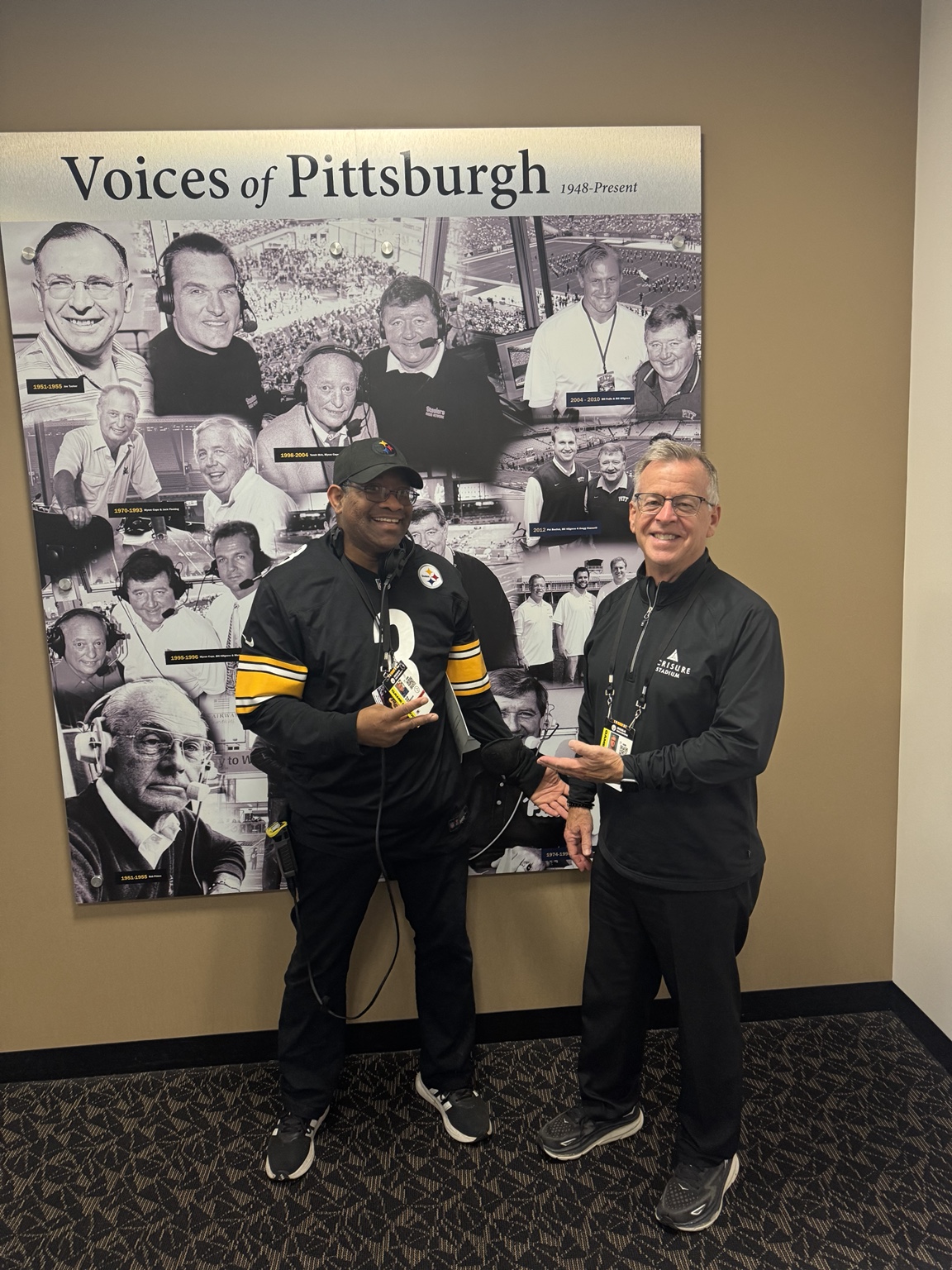 DJ Holland with a Steelers communications colleague beside the Voices of Pittsburgh display